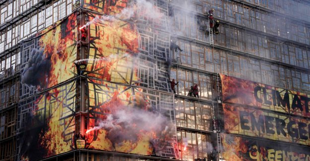 Activists wraps the building in a false flammehav before EU summit
