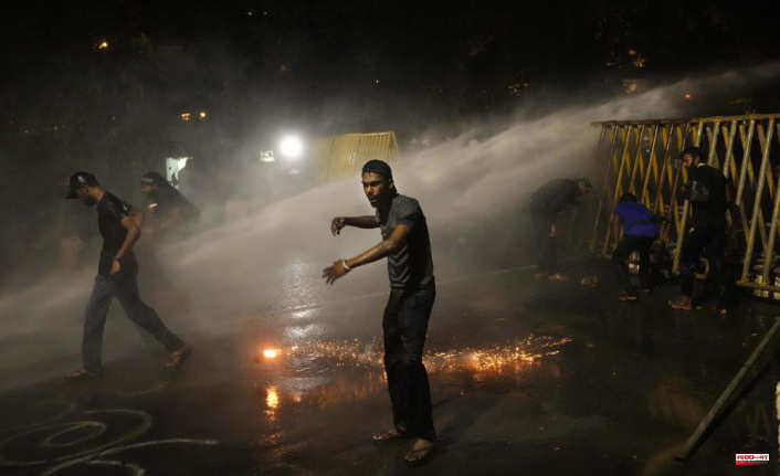 Protesters against the president in Sri Lanka are being tear gassed by police officers