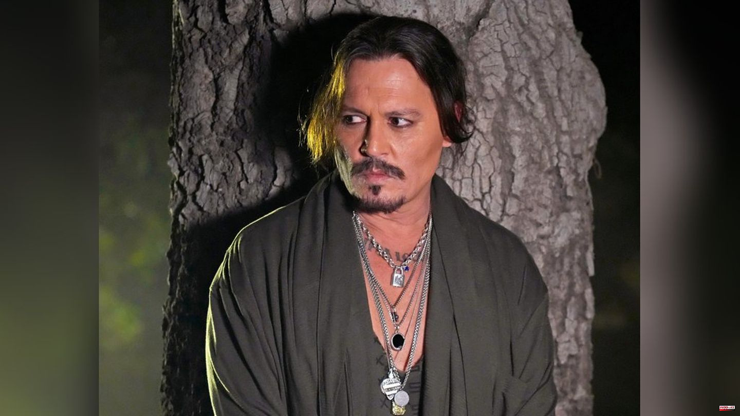 Rihanna fashion show: Johnny Depp stands in his pajamas in the forest
