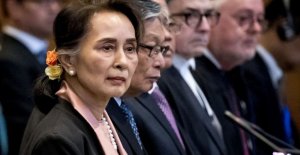 Aung San Suu Kyi sat motionless and heard about the...
