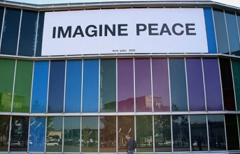 Yoko Ono displays a banner on the Musac façade with her work 'Imagine Peace'