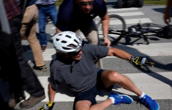 Joe Biden falls off his bike during a ride through...